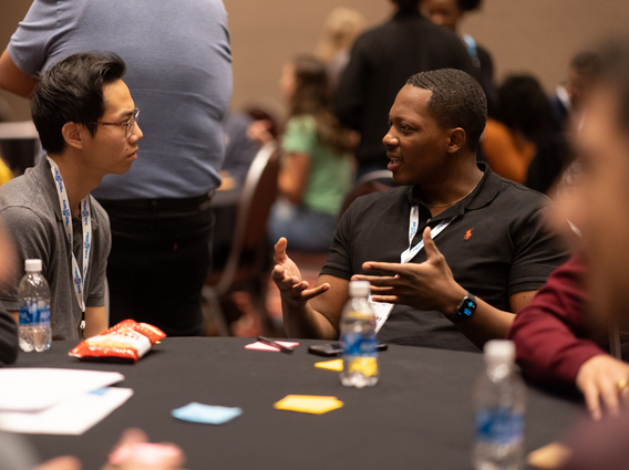 Employees talking at the Employee Network Summit